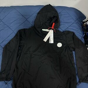 Windbreaker
Packaway rain pullover in black. Off-White™ rubber patch at front.